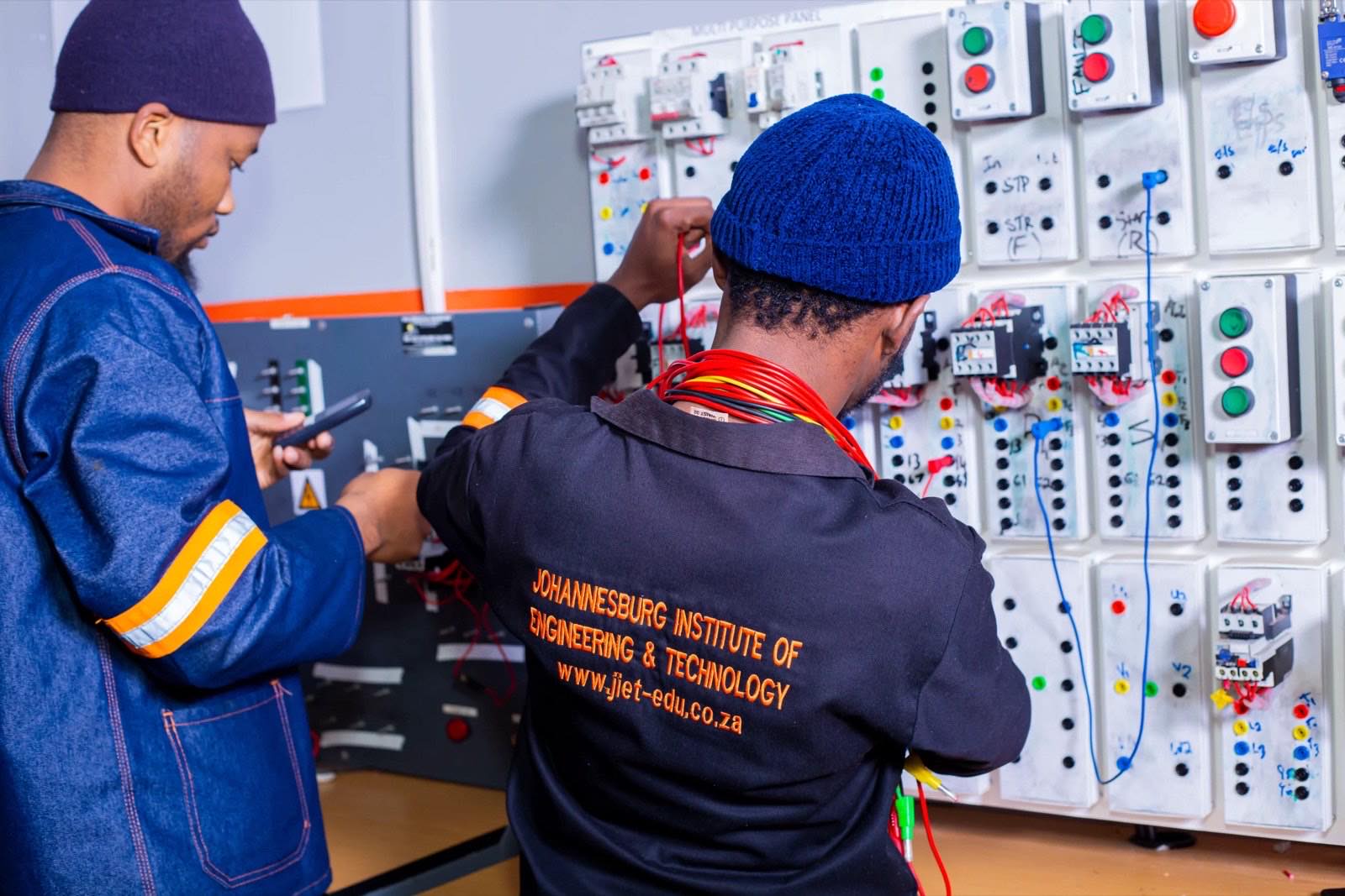 A learner wiring an electrical control panel
